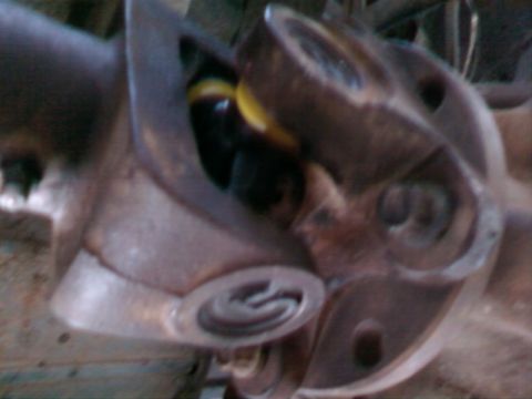 1995 Ford Bronco - A close-up view of a rusty drivetrain component, possibly from a Ford Bronco.