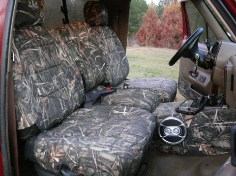 1988 Ford Bronco - Vehicle interior camouflage seat covers and a steering wheel.