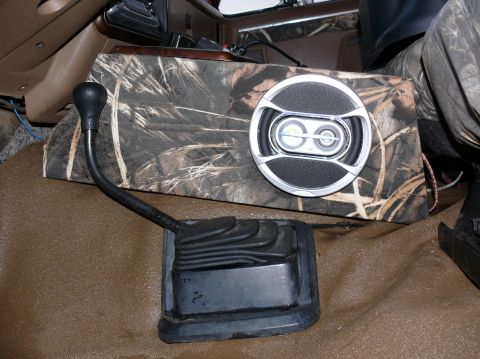 1988 Ford Bronco - Interior view of a vehicle's gear shifter and a custom speaker box with a camouflage pattern.