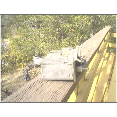1972 Ford Ranchero - An automotive electrical component with visible text is pictured outdoors on a wooden structure.