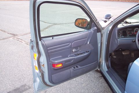 2001 Ford Crown Victoria - Interior view of a 2001 Ford Crown Victoria, focusing on the driver's side door and dashboard.