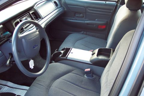 2001 Ford Crown Victoria - The interior of a 2001 Ford Crown Victoria, the driver's side controls and passenger seating.