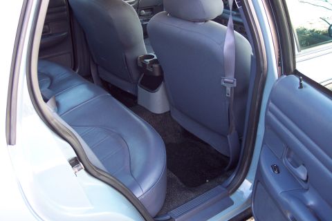 2001 Ford Crown Victoria - The interior of a 2001 Ford Crown Victoria, showing the rear seating area and door panel.