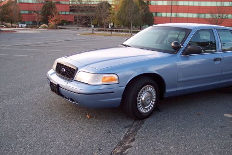 2001 Ford Crown Victoria - Front 3/4 view of a blue 2001 Ford Crown Victoria sedan.