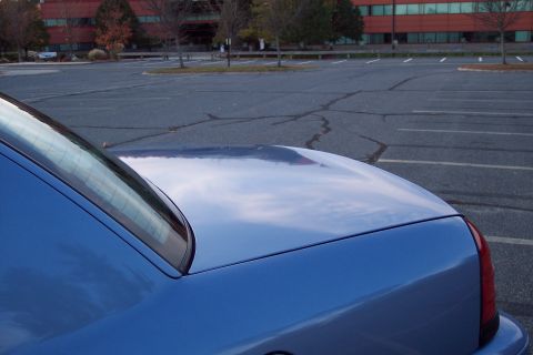 2001 Ford Crown Victoria - Rear view of a blue 2001 Ford Crown Victoria, showing the trunk and quarter panel.