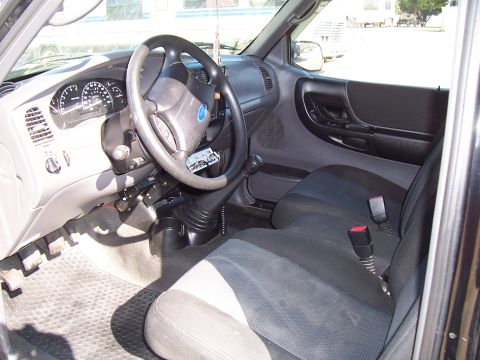 2003 Ford Ranger - Interior view of a 2003 Ford Ranger, highlighting the dashboard and seating area.