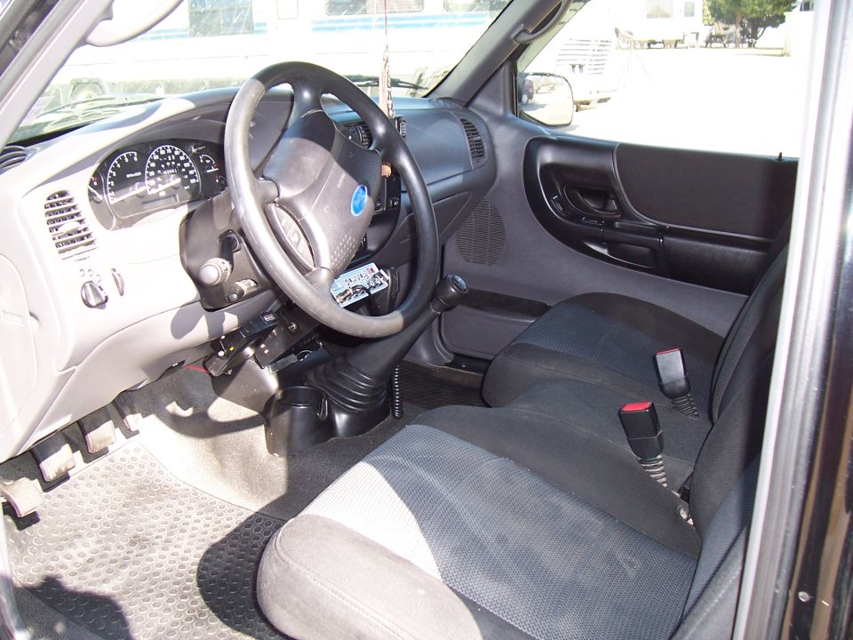 2003 Ford Ranger interior showing dashboard, steering wheel, seats, and gear shifter