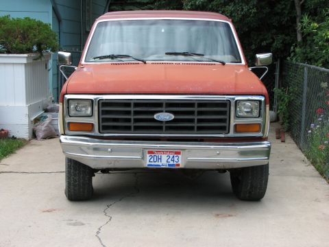 1986 Ford Bronco - Front view of a red 1986 Ford Bronco, showing its grille and South Dakota license plate.