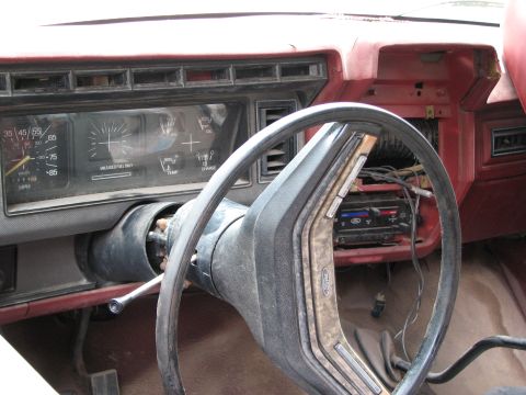 1986 Ford Bronco - Dashboard and steering wheel of a 1986 Ford Bronco, with radio visible.