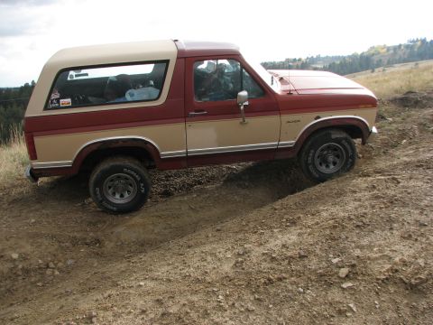 1986 Ford Bronco - This 1986 Ford Bronco is navigating a challenging off-road path.