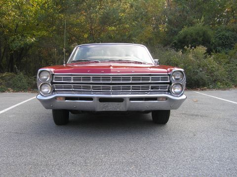 1967 Ford Galaxie - The front grille and headlights of a classic red Ford Galaxie are visible.
