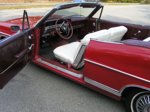 1967 Ford Galaxie - Interior view of a red 1967 Ford Galaxie convertible, its white seats and maroon trim.