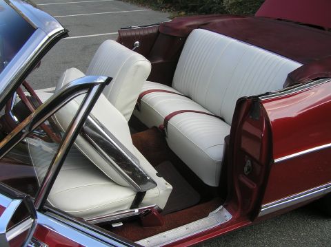 1967 Ford Galaxie - Interior of a 1967 Ford Galaxie convertible with white seats and maroon trim.