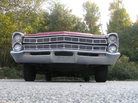 1967 Ford Galaxie - The distinctive grille and dual headlights of a 1967 Ford Galaxie are shown from a low angle.