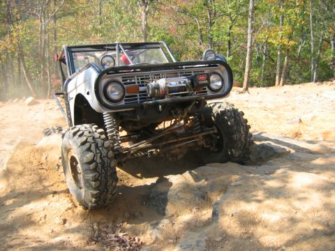 1992 Ford Mustang - This modified 1966 Ford Bronco navigates a rocky trail with its front end prominently displayed, a winch mounted on the grille.