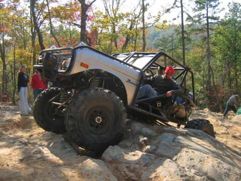 1992 Ford Mustang - Customized Ford Bronco navigating a challenging rocky trail during an off-road excursion.