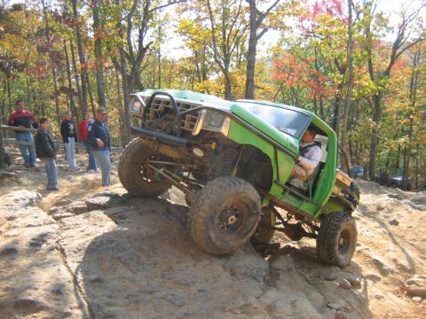 1992 Ford Mustang - Off-road vehicle navigates a challenging rocky terrain during an outdoor event.