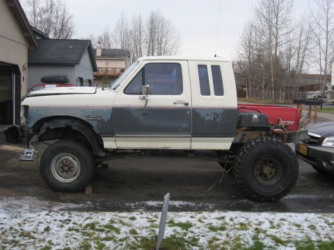 1990 Ford F-250 - This modified 1990 Ford F-250 features an extended cab and oversized tires for off-road use.