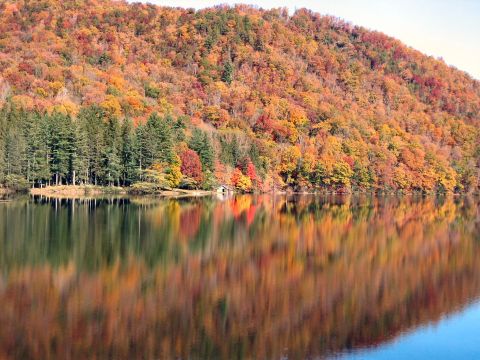1985 Ford LTD Crown Victoria - Fall foliage colors the hillside and reflects in the still water of the lake.