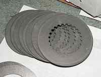 1996 Ford Bronco - Multiple clutch plates are stacked together, showing their textured friction surfaces.