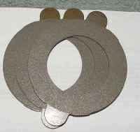 1996 Ford Bronco - A set of clutch plates, likely for a vehicle transmission, are shown stacked together.