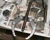 1996 Ford Bronco - Gear puller tool and socket wrench are on top of a newspaper.