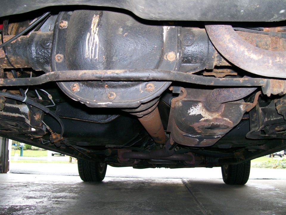 1995 Mercury Grand Marquis rear differential and exhaust system, viewed from underneath. The differential housing has white markings