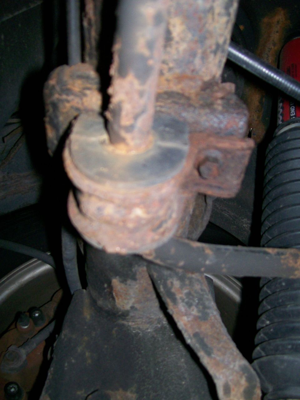 Rusted suspension part with rubber bushing