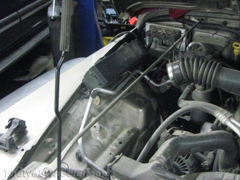 1987 Suzuki Samurai - Close-up view of engine bay components including air intake and fuse box.