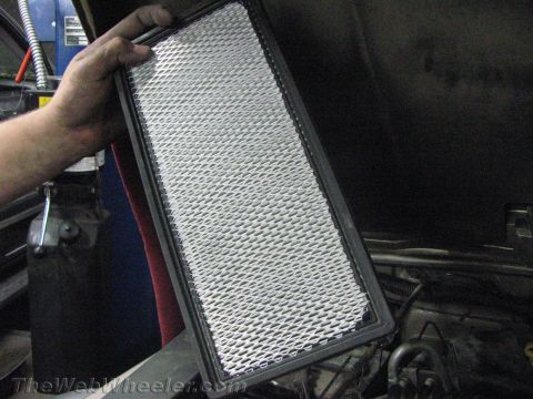 1987 Suzuki Samurai - A person is holding a used air filter, likely for replacement in a vehicle.
