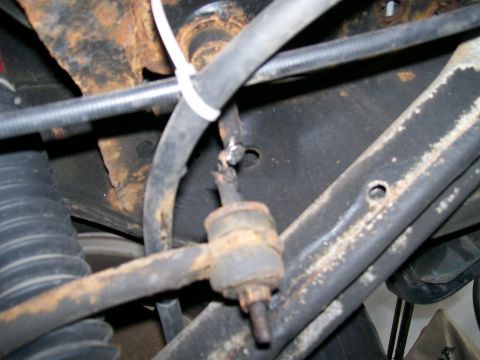 1995 Mercury Grand Marquis - This image shows a close-up view of vehicle suspension components, including a sway bar link and hoses.
