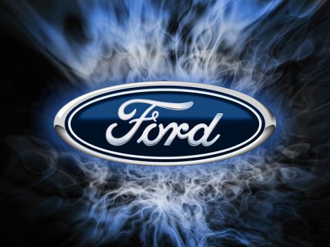 1990 Ford Bronco - Ford logo displayed against a backdrop of blue smoke, with "SUPERMOTORS" visible at the bottom.