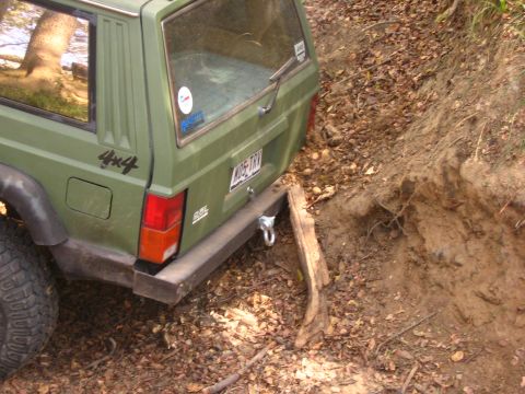 2001 Jeep Wrangler - Green Jeep Cherokee XJ with 4x4 decal navigating a dirt path during an off-road excursion.