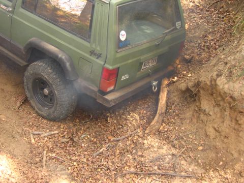 2001 Jeep Wrangler - Rear view of a green Jeep Cherokee XJ navigating an off-road trail.