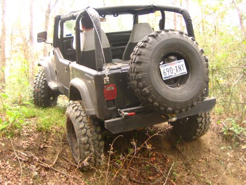 2001 Jeep Wrangler - This Jeep Wrangler is equipped for off-road use, with large tires and a spare wheel on the rear.