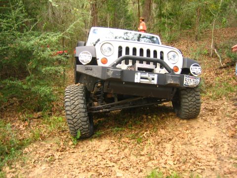 2001 Jeep Wrangler - This white Jeep Wrangler, identified as a 2001 model, is shown in a wooded area with its front end prominently displayed, a winch and custo…