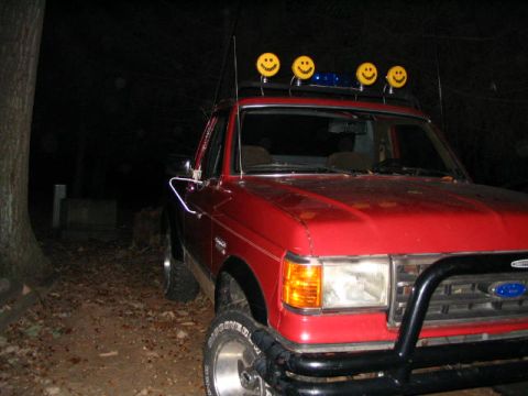 1989 Ford Bronco - This 1989 Ford Bronco features a custom roof rack adorned with smiley face lights and a blue light bar.