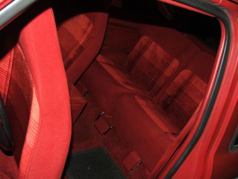 1989 Ford Bronco II - Interior view of a car with red seats and carpet.