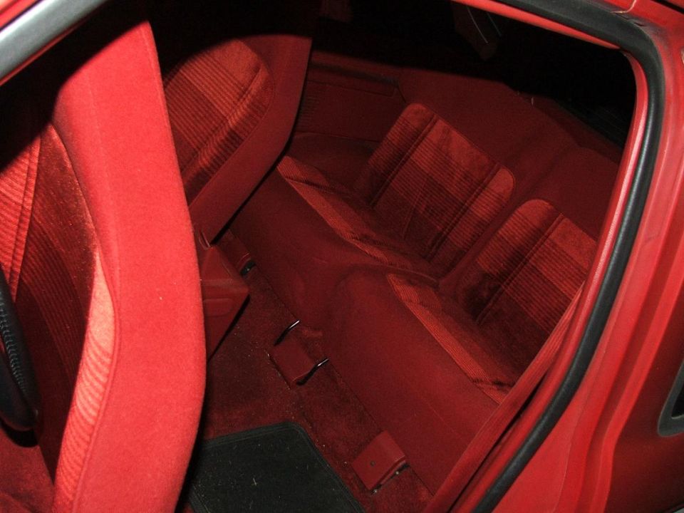 Red fabric seats and carpet inside a car