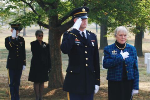 1991 Ford Bronco - A solemn ceremony unfolds with uniformed soldiers and civilians paying respects at a memorial site.