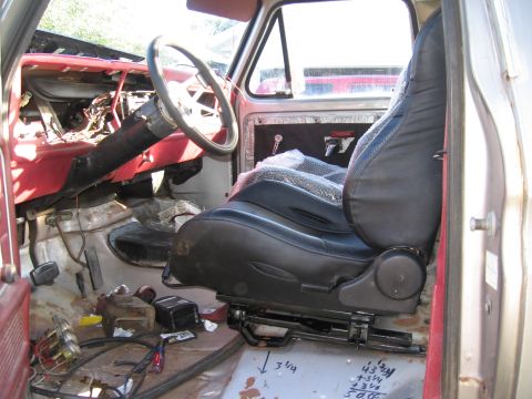1979 Ford F-150 - The interior of a 1979 Ford F-150, a new driver's seat and a partially disassembled dashboard.