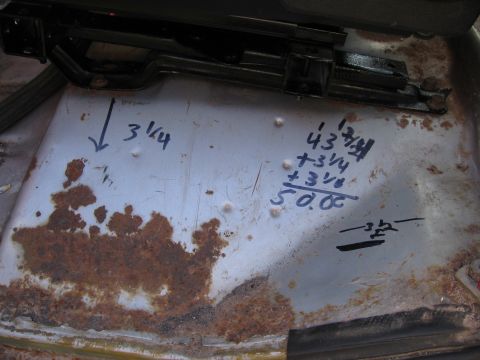 1979 Ford F-150 - Handwritten measurements and calculations are visible on the corroded floor of a vehicle's interior.