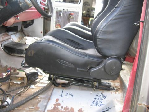 1979 Ford F-150 - Measurements are marked on the floor of a vehicle's interior, focusing on the black bucket seats.