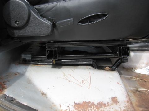 1979 Ford F-150 - Close-up of seat mounting hardware on a vehicle floor.