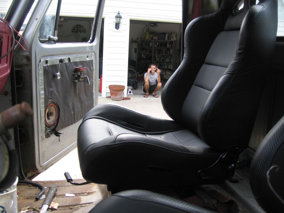 Black racing seats inside a vehicle with the door open