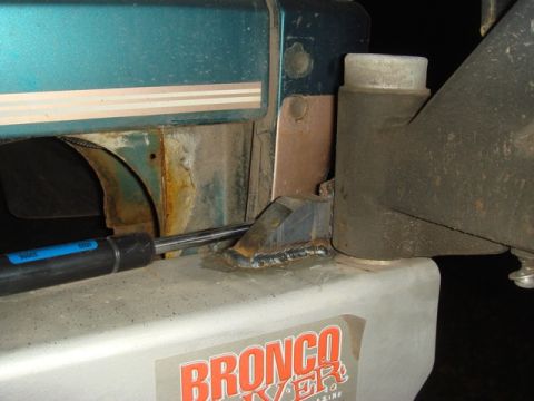 1996 Ford Bronco - A close-up of a 1996 Ford Bronco bumper stop reveals a "BRONCO" sticker and evidence of recent welding.