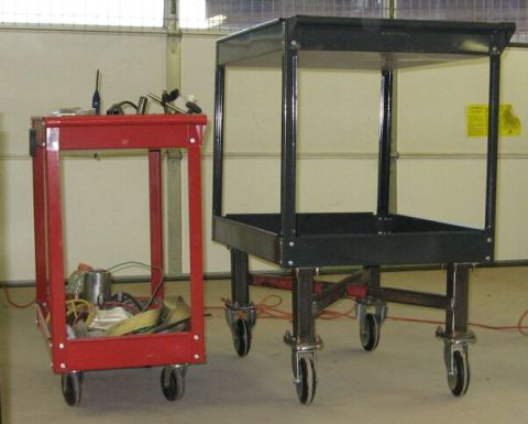 1990 Ford Bronco - Two rolling carts are shown in a garage, one red and one black.