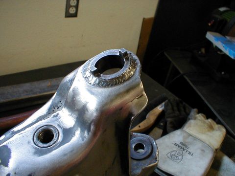 1996 Ford Bronco - A close-up view of a metal suspension component, likely undergoing repair or modification.