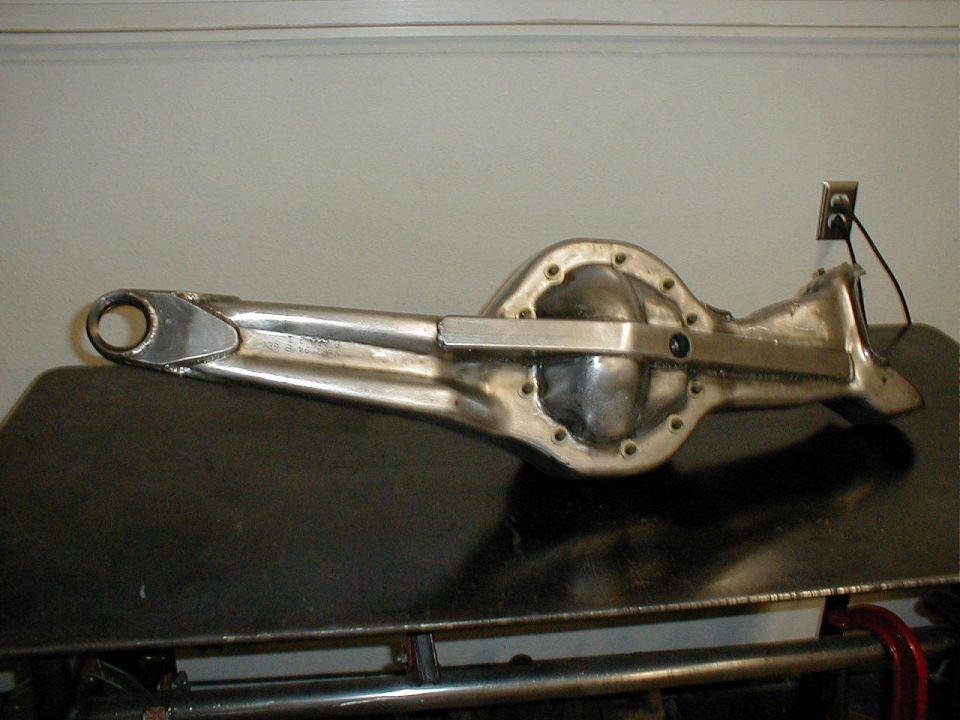Polished metal rear axle differential housing with a long snout and mounting bracket