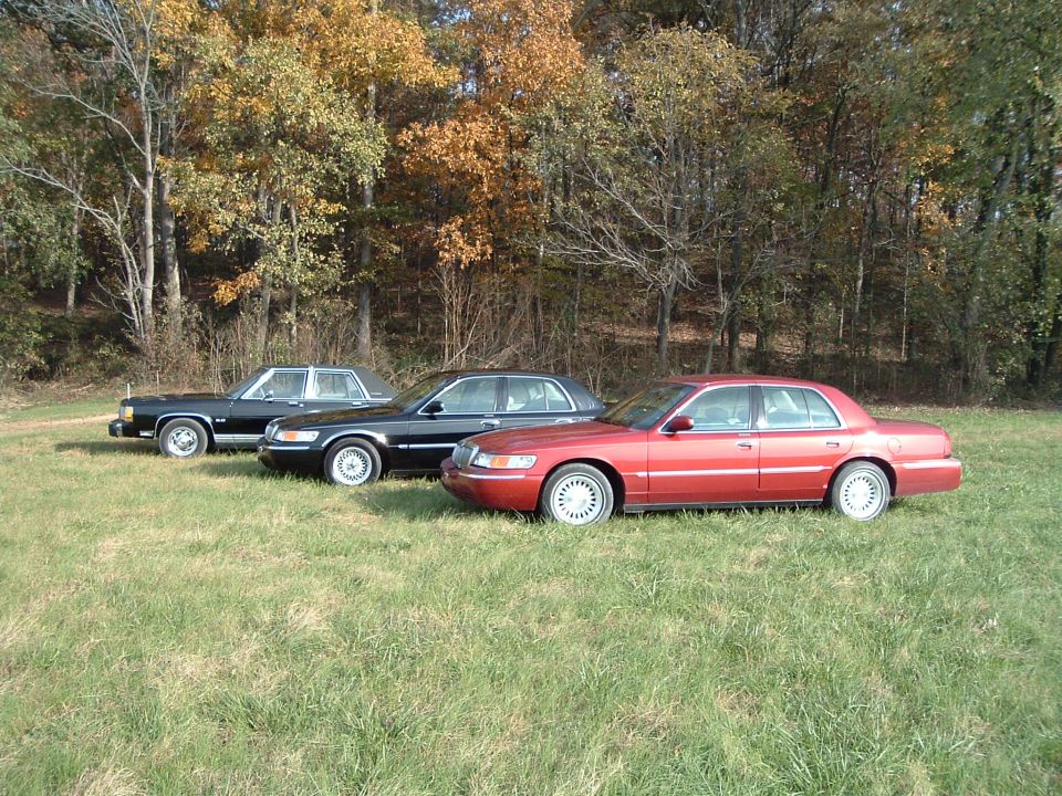 Red 2001 Mercury Grand Marquis parked in a field